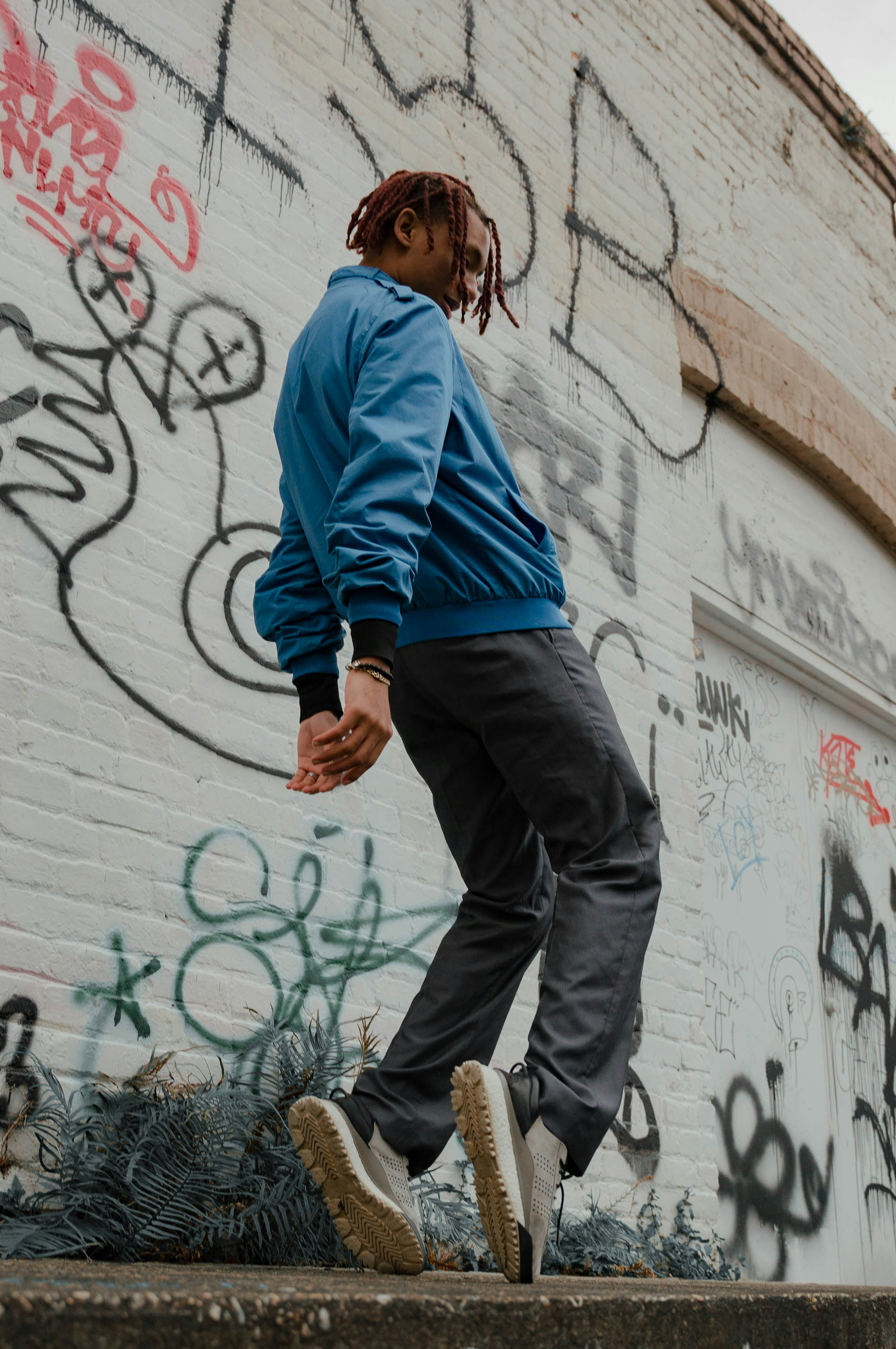 man dancing in front of graffiti background
